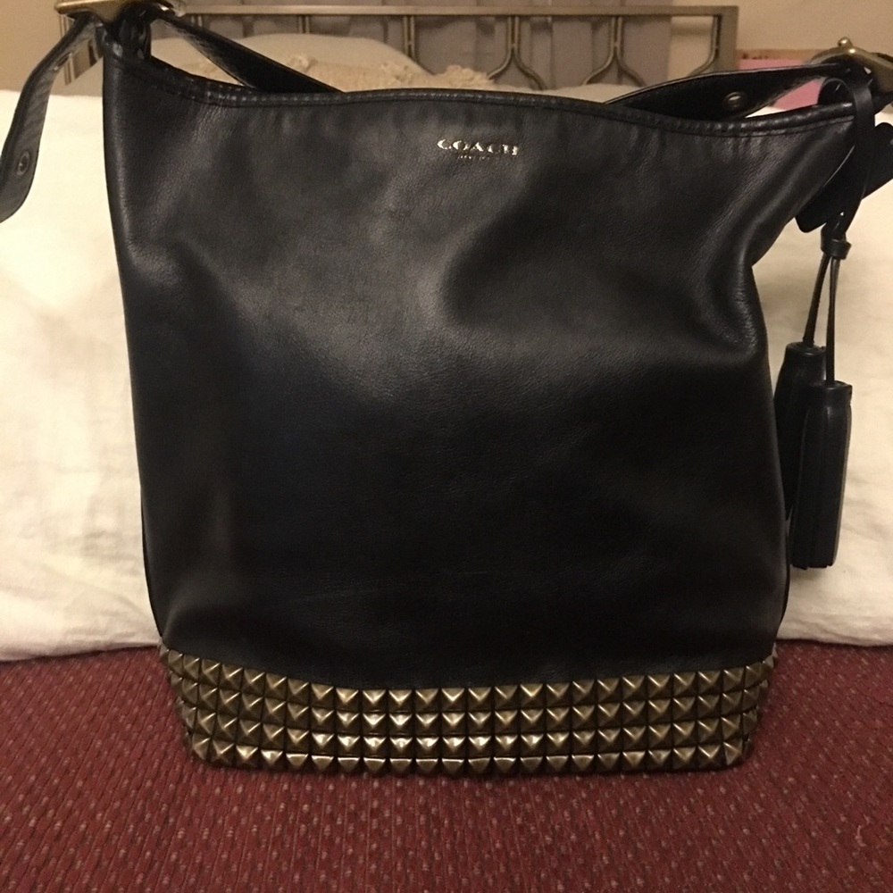 Coach legacy bucket bag with brass studs.